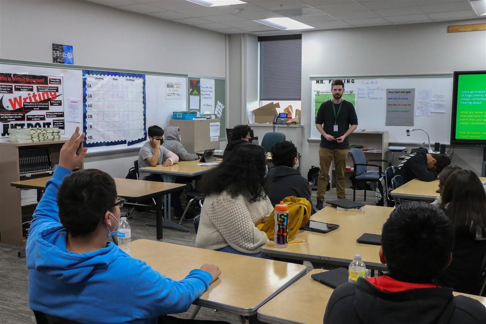 A student raises his hand in class